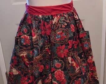 May include: A Christmas-themed apron with a red waistband and pockets. The apron features a dark background with a pattern of red poinsettias, roses, Santa Claus figures, and holly leaves. The apron is designed for kitchen use.