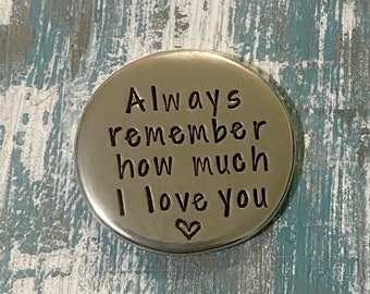 May include: A silver metal disc with the words "Always remember how much I love you" engraved on it. A small heart symbol is also engraved on the disc.