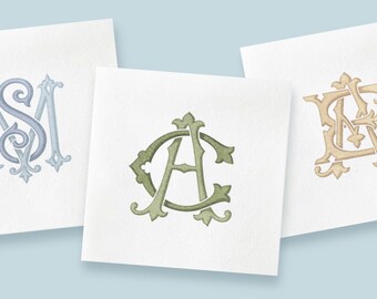 May include: Three monogram designs on white paper. The monograms are in different colors: light blue, green, and gold. The letters are stylized with decorative flourishes, perfect for personalized stationery or wedding invitations.