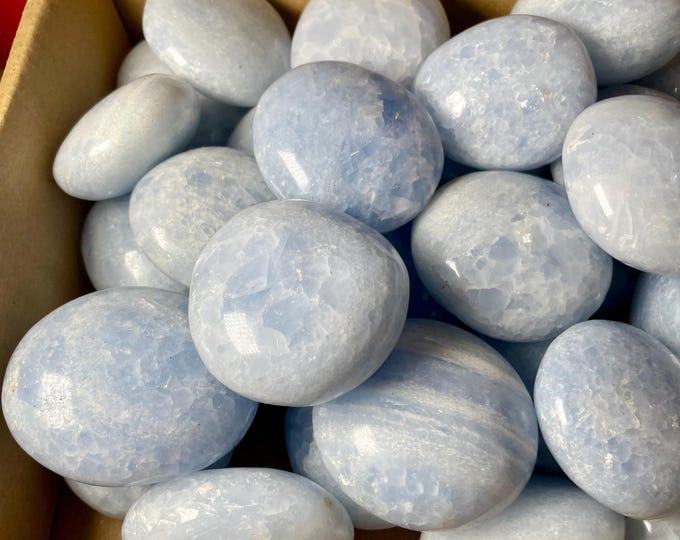 one  Blue Calcite Hand Carved Crystal Blue Calcite palm stone Specimen has imperfections