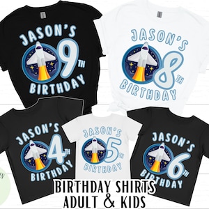 May include: Several black and white t-shirts with a rocket ship design and the text "JASON'S BIRTHDAY". The shirts display the numbers 4, 5, 6, 8, and 9. The words "BIRTHDAY SHIRTS ADULT & KIDS" are also visible.