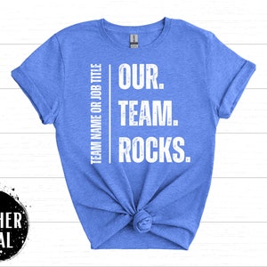 May include: A blue t-shirt with white text that reads "TEAM NAME OR JOB TITLE OUR. TEAM. ROCKS."