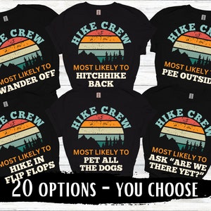May include: Six black t-shirts with a retro sunset graphic and the text "HIKE CREW" in white. Each shirt has a different funny saying about hiking, such as "Most Likely to Wander Off" and "Most Likely to Hitchhike Back".