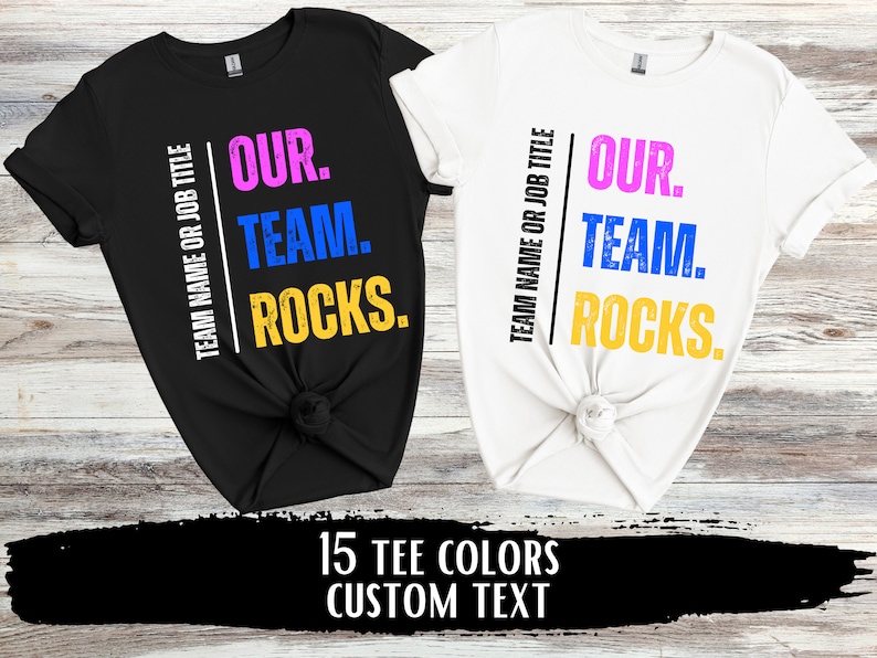 May include: Two t-shirts, one black and one white, with the text "TEAM NAME OR JOB TITLE OUR. TEAM. ROCKS." printed on them. The text is in different colors, including pink, blue, and yellow.