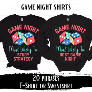 May include: Two black t-shirts with a dice graphic and the text "Game Night Most Likely To" with different phrases on each shirt. The first shirt says "Study Strategy" and the second shirt says "Host Game Night".