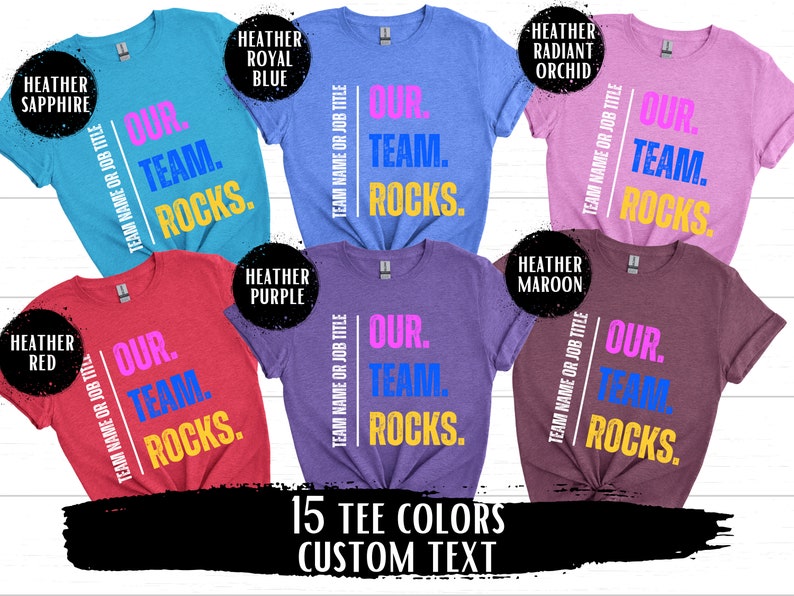 May include: A collage of 10 t-shirts in different colors, each featuring the text "OUR. TEAM. ROCKS." in various colors. The text is centered on the shirts and is surrounded by a white border. The shirts are arranged in a grid pattern, with the colors alternating between light and dark. The text "15 TEE COLORS CUSTOM TEXT" is displayed at the bottom of the image.