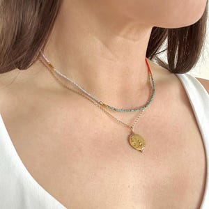 Model wearing the necklace and a layering necklace.