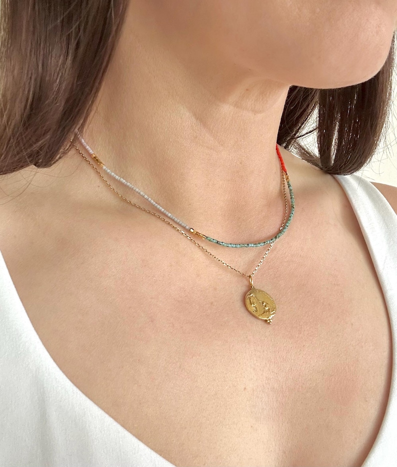 Model wearing the necklace and a layering necklace.