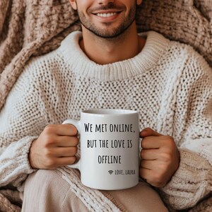 May include: White ceramic mug with black text that reads "We met online, but the love is offline" with a wifi symbol and the text "LOVE, LAURA".