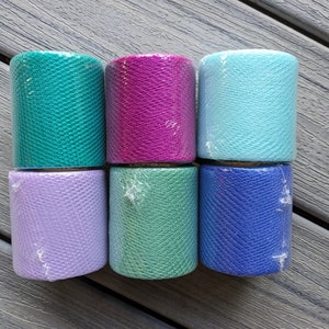 May include: Six rolls of mesh ribbon in various colors, including teal, magenta, light blue, lavender, green, and blue.