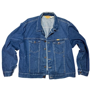 May include: A blue denim jacket with a button-up front, two chest pockets, and two side pockets. The jacket has a collared neckline and a classic, vintage style. The brand name "RUSTLER" is visible on a small tag.