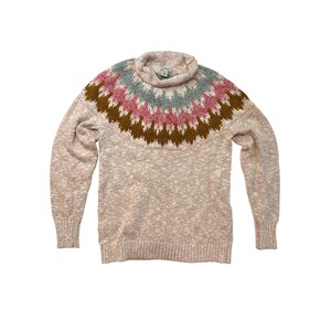 May include: A beige turtleneck sweater with a colorful geometric pattern across the chest. The pattern includes shades of brown, pink, and teal. The sweater has long sleeves and a ribbed hem and cuffs.