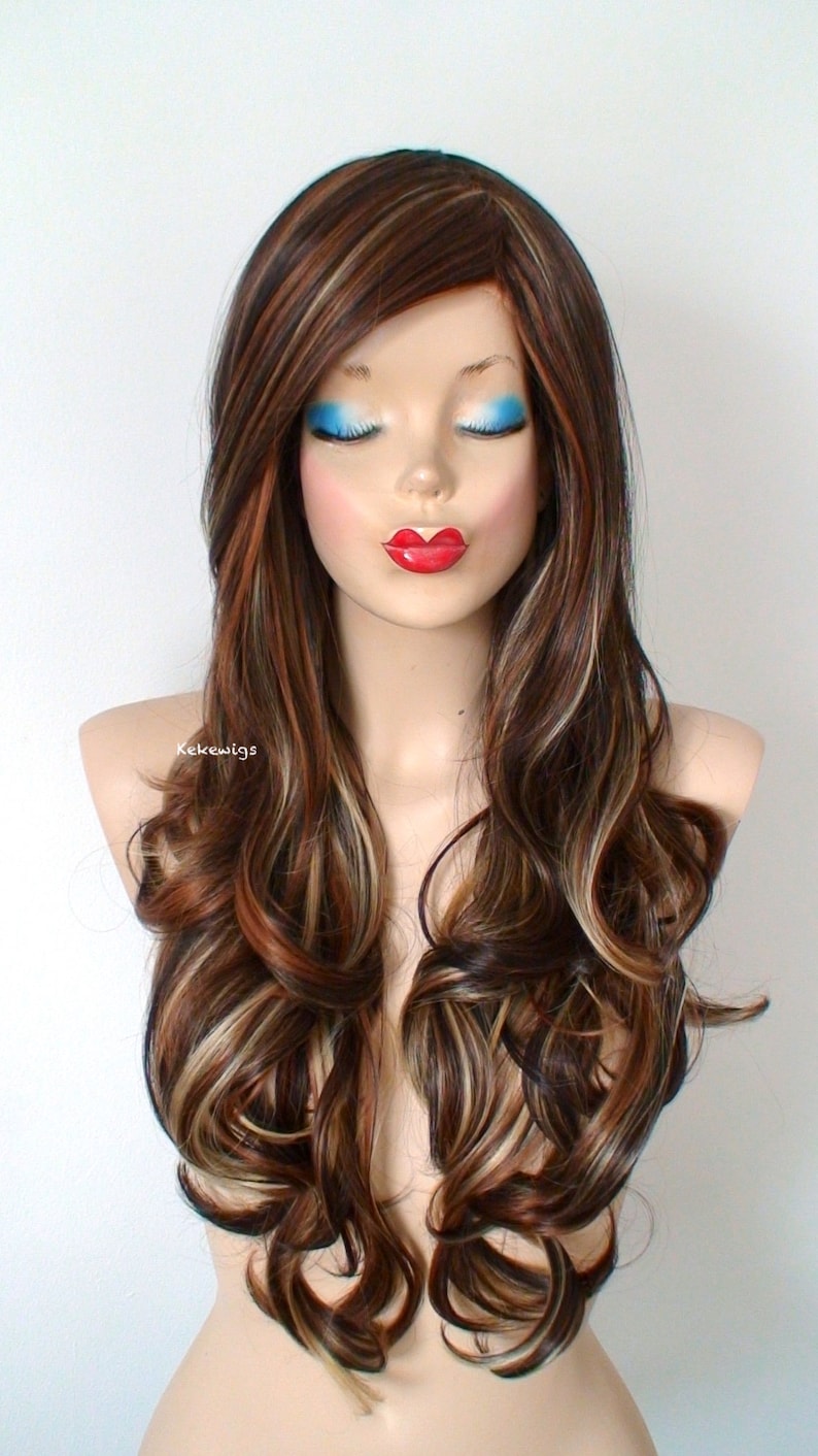 May include: Long brown wig with blonde highlights and loose curls. The wig is styled with a side part and falls to the shoulders.