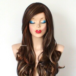 May include: Long, wavy brown wig with blonde highlights. The wig is styled with loose curls and a side part.