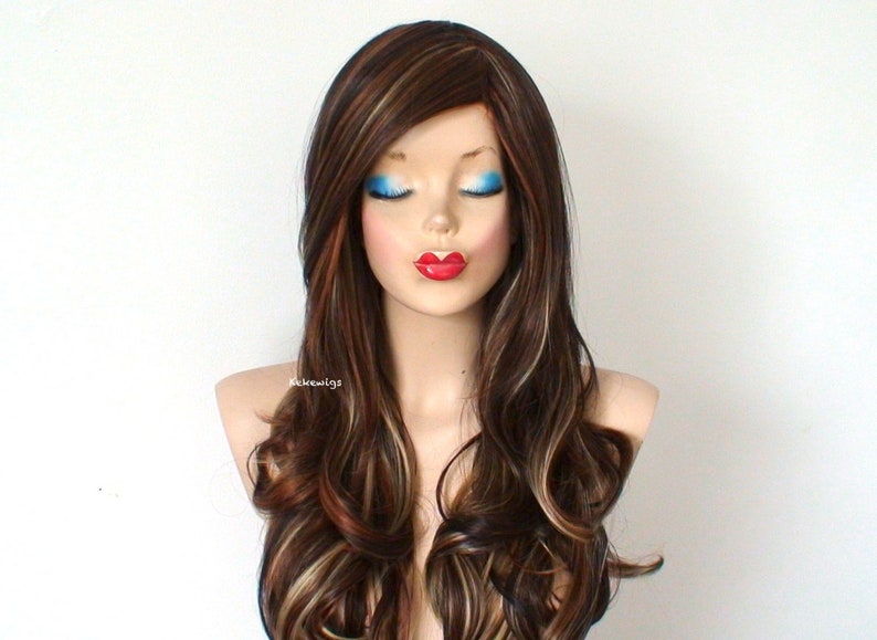 May include: Long, wavy brown wig with blonde highlights. The wig is styled with loose curls and a side part.