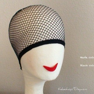 May include: A black mesh wig cap with a nude color option. The cap is shown on a white mannequin head.