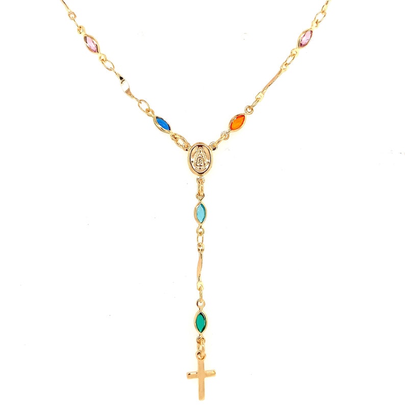 May include: Gold chain necklace with a small cross charm and a pendant featuring the Virgin Mary. The necklace is adorned with colorful oval-shaped stones.