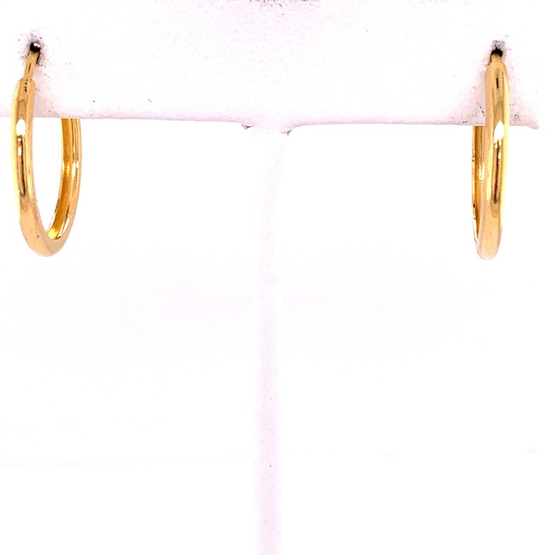May include: A pair of gold hoop earrings. The earrings are simple and classic, and they would be a great addition to any jewelry collection.