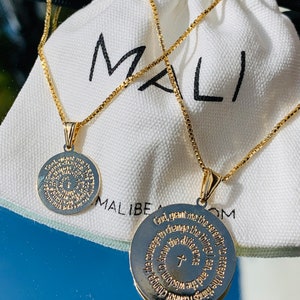 May include: Two gold necklaces with circular pendants featuring engraved text. The text on the pendants reads "God, grant me the serenity to accept the things I cannot change, courage to change the things I can, and the wisdom to know the difference." and "God, grant me the serenity to accept the things I cannot change, courage to change the things I can, and the wisdom to know the difference."