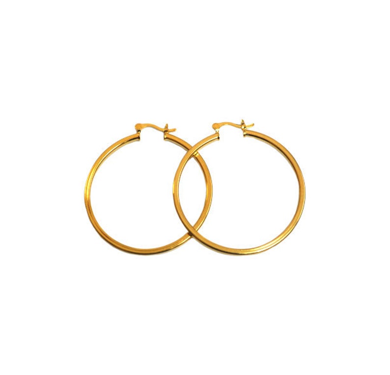 May include: A pair of gold hoop earrings. The earrings are simple and classic, and they would be a great addition to any jewelry collection.