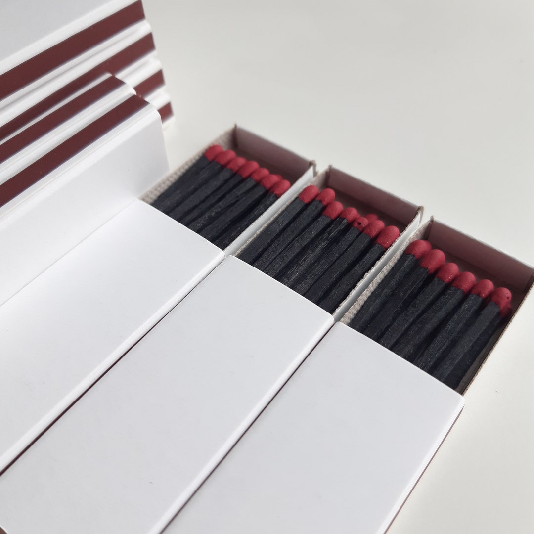25 White Plain Matchboxes, Filled With Black Wooden Sticks With Bordo