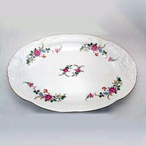 May include: White oval serving platter with a gold rim and a floral design featuring pink, yellow, and blue flowers.