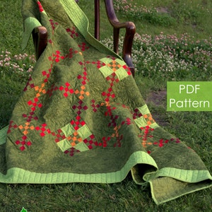 May include: A green, red and orange quilt pattern with the text "Urban Amish" and "PDF Pattern" on a green grassy background.