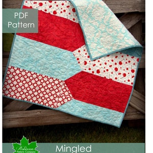 May include: A PDF pattern for a quilt called "Mingled" by Robinson Pattern Company. The quilt is made of red, white and blue fabric with a cherry print, polka dot print and a geometric pattern. The quilt is folded and draped over a wooden fence.