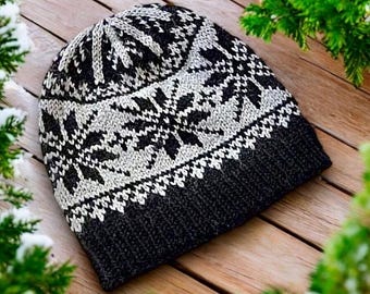 May include: A knitted beanie hat in black, white, and gray. The hat features a geometric snowflake pattern and a ribbed brim. The hat is made of a soft, warm material, perfect for cold weather. The hat is a stylish accessory for any outfit.