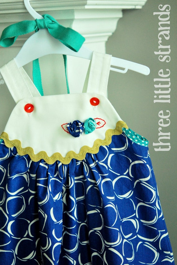 Items similar to Blue Apron Dress with Flower Accents on Etsy
