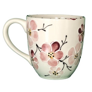 Large handmade ceramic coffee mug, hand painted with pink cherry blossoms.  It's large handle is comfortable and easy to hold. A great gift,