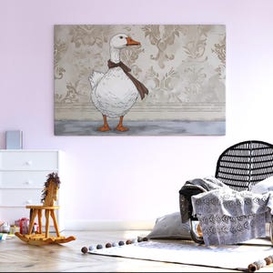 May include: A framed canvas print featuring a cartoon goose wearing a brown scarf. The goose is white with orange feet and beak, set against a vintage floral wallpaper background. The artwork is displayed in a child's room.