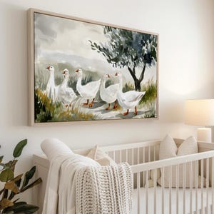 May include: A framed canvas art print depicts five white geese walking in a line. The artwork features a muted color palette with a tree and grassy area. The painting is displayed above a white crib.