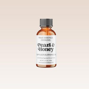 May include: A brown glass bottle with a black cap and a white label. The label reads "TRUE ESSENCE -DESIGNS- Pears & Honey DIFFUSER BURNING OIL enchanting fragrance for your home NET WT. 2 FLOZ | 60ML www.trueessence-designs.com"