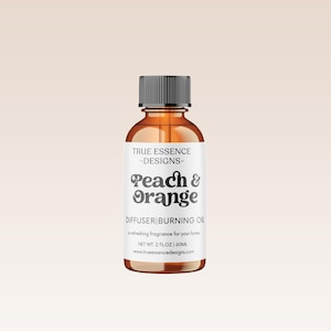 May include: A brown glass bottle with a black cap and a white label. The label says "TRUE ESSENCE -DESIGNS- Peach & Orange DIFFUSER BURNING OIL A refreshing fragrance for your home NET WT. 2 FLOZ 60ML trueessencedesign.com"
