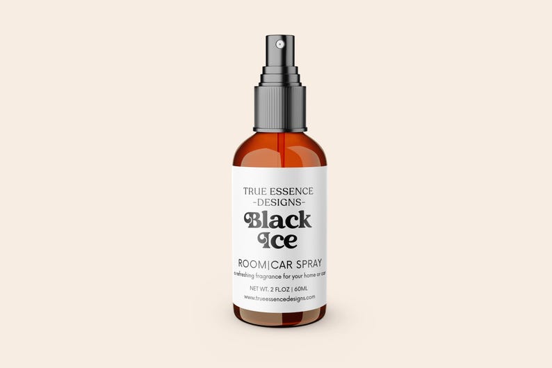 May include: A brown glass spray bottle with a black cap and a white label. The label reads "Black Ice ROOM|CAR SPRAY" in a stylized font. The bottle contains 2 fl oz of product.
