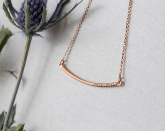 Rose gold filled necklace with a curved bar charm and white zircons made of gold filled silver