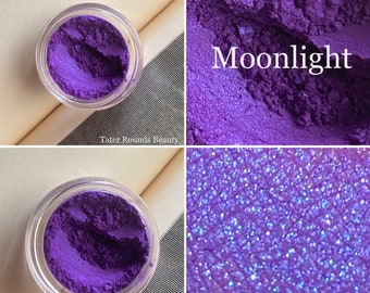 May include: A small jar of purple eyeshadow with a shimmery finish. The eyeshadow is labeled "Moonlight".