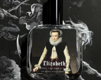 May include: A clear glass perfume bottle with a black cap. The bottle features a portrait of a woman in historical attire, with the name "Elizabeth" and scent notes printed below. The background is a dark, detailed illustration.