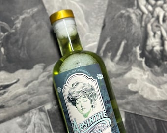 May include: A green glass bottle with a gold lid and a label that says "Absinthe Vegan Glycolic Acid Toner 6 oz". The label features a vintage illustration of a woman with a floral design.