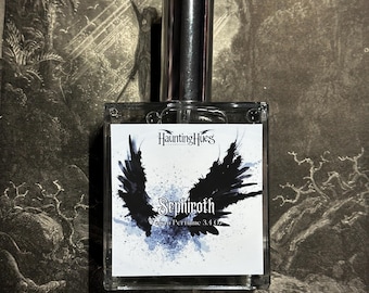 May include: A clear glass bottle of perfume with a silver cap. The label is white with black text that reads "Haunting Hues" and "Sephiroth Vex Perfume 3.4 oz". A black and white image of wings is behind the text.