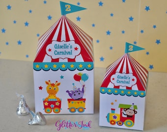 May include: Two red and white striped circus tent shaped boxes with a blue flag on top. The larger box has a giraffe and a hippo on a train. The smaller box has a monkey on a train. Both boxes say "Giselle's Carnival" on the front.