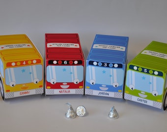 May include: Four colorful bus-shaped boxes with personalized names, "Sammy", "Natalia", "Jordan", and "Carter", and numbers 4, 6, 3, and 5 on the front. The boxes are decorated with stars and have a cartoon bus face.