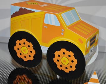 May include: A yellow toy dump truck with black wheels and a brown dirt bed. The truck has a white star on the side and the number 8 on the top. The truck is sitting on a gray and white patterned surface. There is a small orange and white traffic cone in the lower right corner of the image.