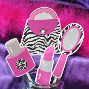 May include: A set of five pink and black party decorations featuring a zebra print handbag, a lipstick, a nail polish bottle, and a hand mirror. The decorations are perfect for a girls' night out or a birthday party.