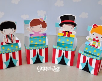 May include: Four colorful cardboard boxes with circus character cutouts on top. Each box has a red and white striped tent design with a blue and black tent flap. The characters are a clown, a magician, a girl in a pink dress, and a boy in a red and white striped shirt.