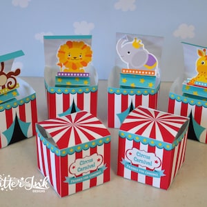May include: Five red and white striped boxes with blue and white star accents. Each box has a different animal on top: a monkey, a lion, an elephant, a giraffe, and a blank box. The boxes say "Circus Carnival" and "Thanks for coming!"