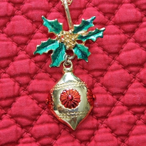 A Christmas Ornament Hangs From a Bough of Holly, Green holly leaves,Red flower on ornament, Christmas gift, Secret Santa gift, Teacher gift
