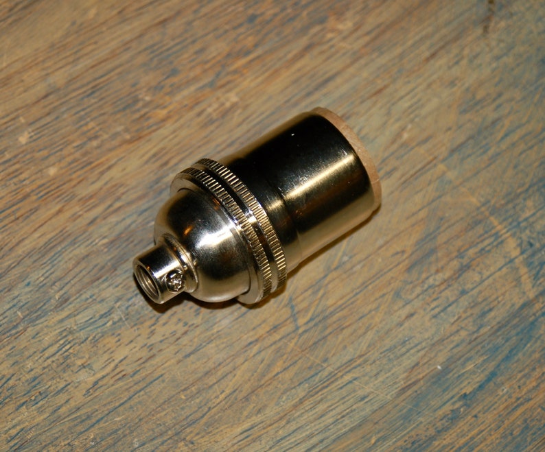 May include: A silver light bulb socket with a threaded end.