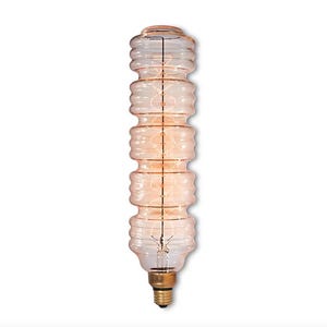 May include: A decorative, clear glass light bulb with a unique, stacked design. The bulb has a warm, amber glow and a brass base. The filament is visible inside the bulb. This vintage-style light bulb is perfect for home decor.